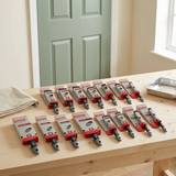 Harris 16-piece synthetic paint brush set on a wooden workbench in a home decorating setting